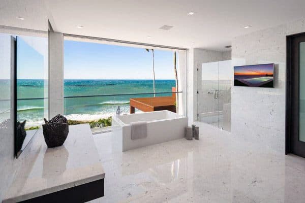 Luxurious bathroom with a bathtub and ocean view through a large window