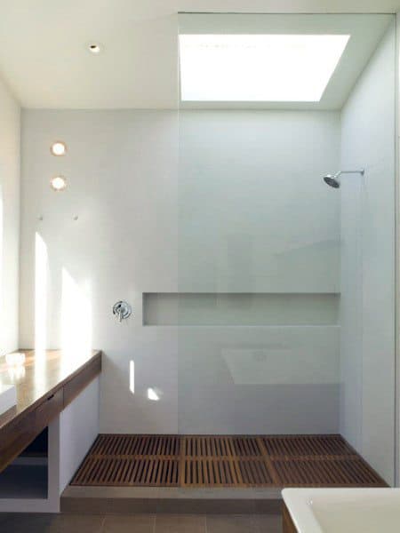 Minimalist bathroom with a skylight, large glass shower, and wooden floor slats