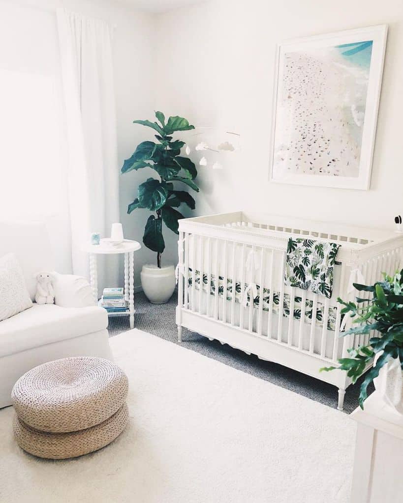 all white nursery crib sofa wicker footrest green plant