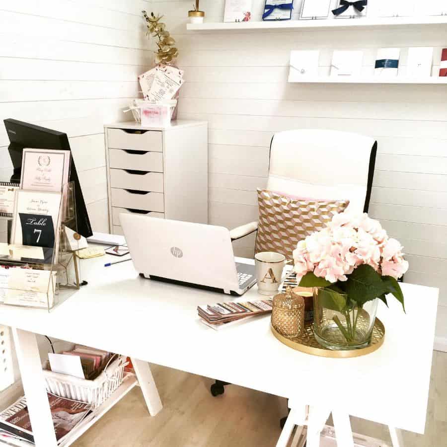 small home office space white shiplap walls white desk and chair tall filing cabinet