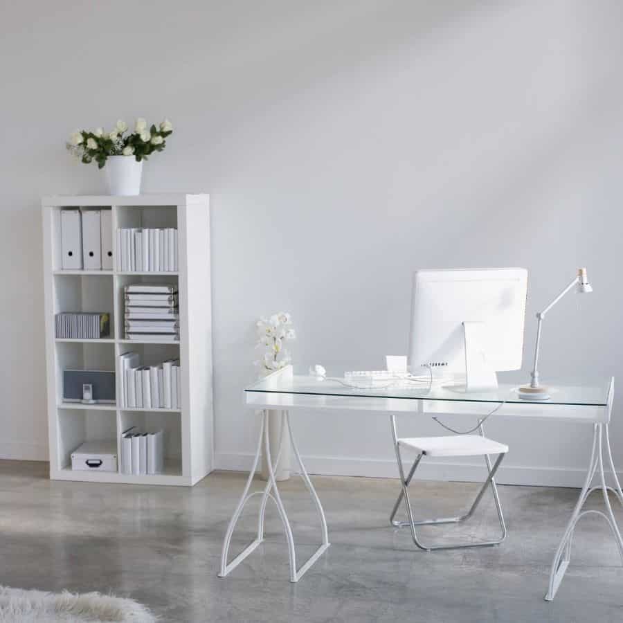 minimalist home office space glass desk white storage unit