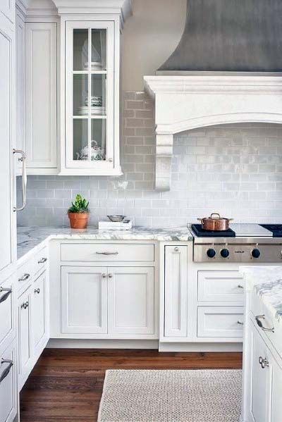 white cabinet kitchen with ornate hood