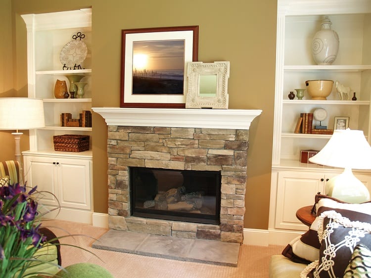 stone fireplace with white painted wood mantel