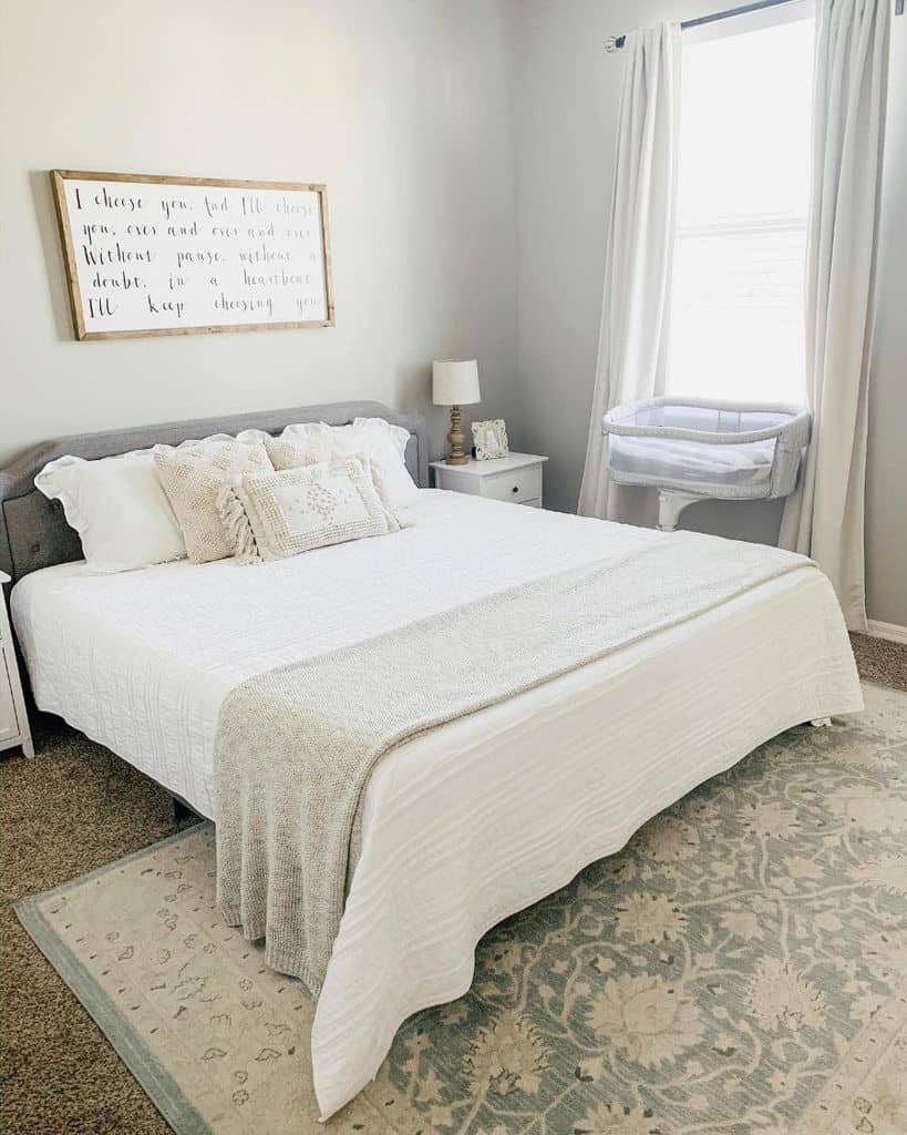 white small master bedroom with pattern floor rug