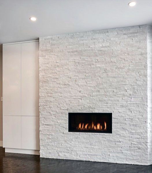 Modern fireplace set in a stacked stone wall with a dark wooden floor