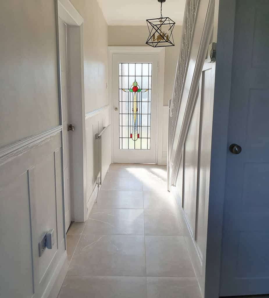 white wall paneling hallway tile floor