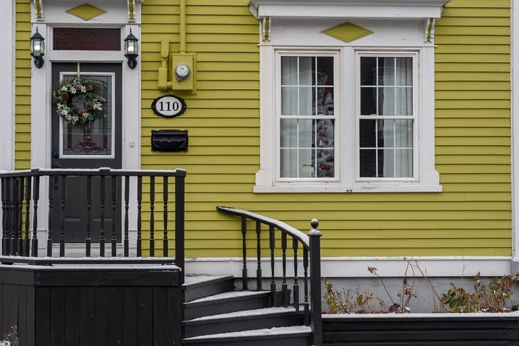 white window trim yellow house