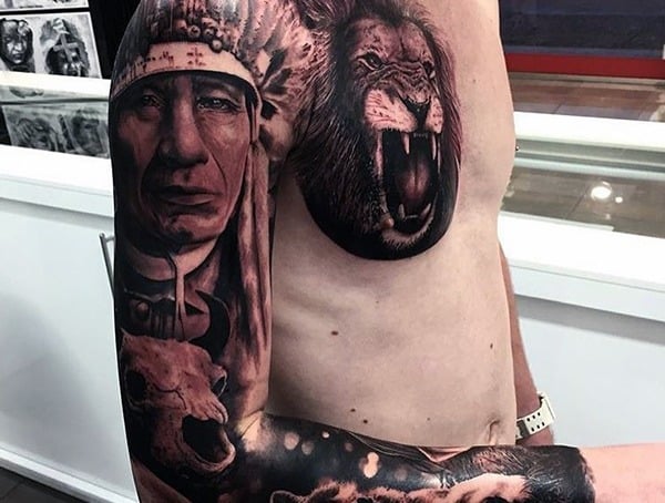 Man with a full sleeve tattoo featuring a Native American chief and a lion on his chest