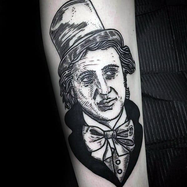 Blackwork Willy Wonka tattoo in a vintage etching style, featuring bold lines, classic top hat, and expressive face with a bow tie.