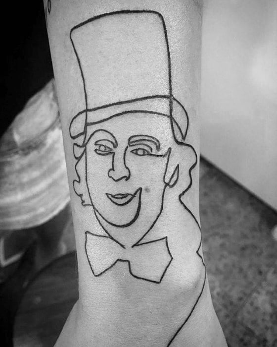 Minimalist Willy Wonka tattoo created with a single continuous line, featuring a top hat, smiling face, and bow tie.