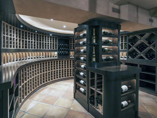 A modern wine cellar with wooden racks and shelves brimming with fine wine bottles
