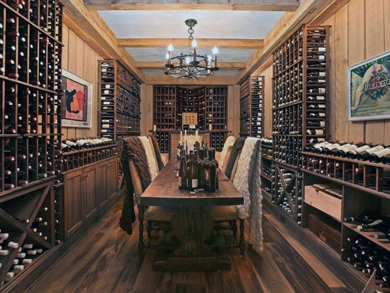 A rustic wine cellar with wooden racks filled with wine bottles and a long wooden table perfect for wine tastings