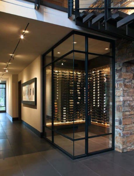 Sleek, modern wine cellar with glass walls, showcasing rows of wine bottles under warm, inviting lighting