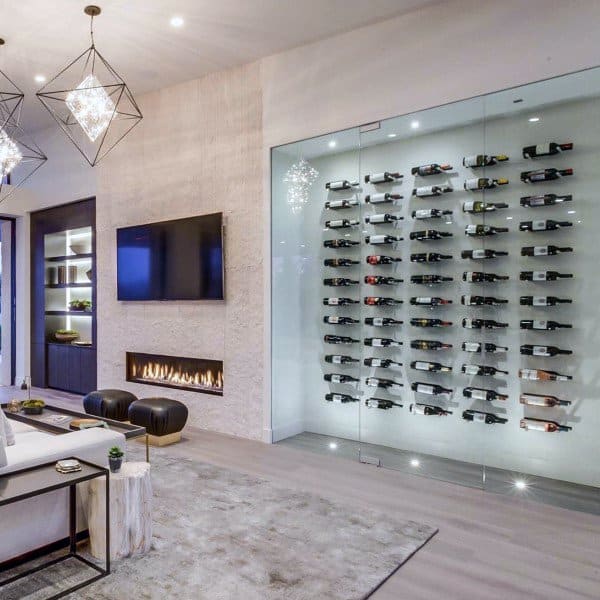 Modern living room with geometric lights, wall-mounted TV, sleek fireplace, and elegant wine display on the wall