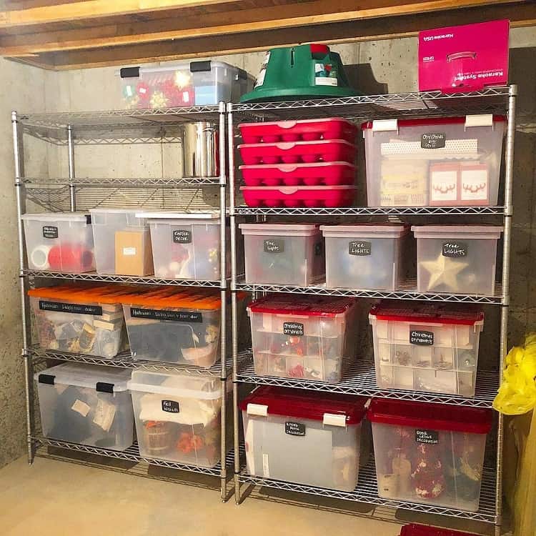 Basement shelves with labeled bins for Christmas decorations and tree storage.