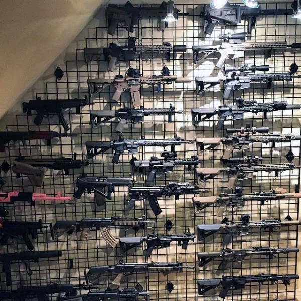 Gun collection displayed on a sleek wire rack system, organized for easy access and visual appeal.