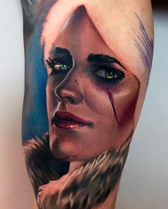 Hyper-realistic Witcher tattoo of Ciri with piercing green eyes, facial scar, and fur collar, set against a soft blue and pink background.