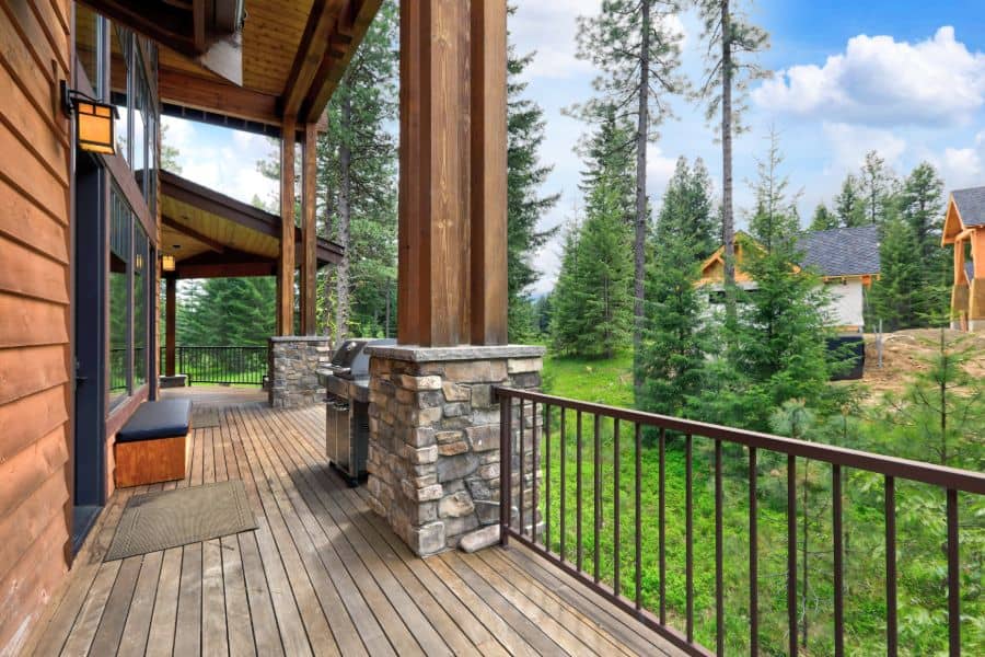 wood cabin front porch with metal railing