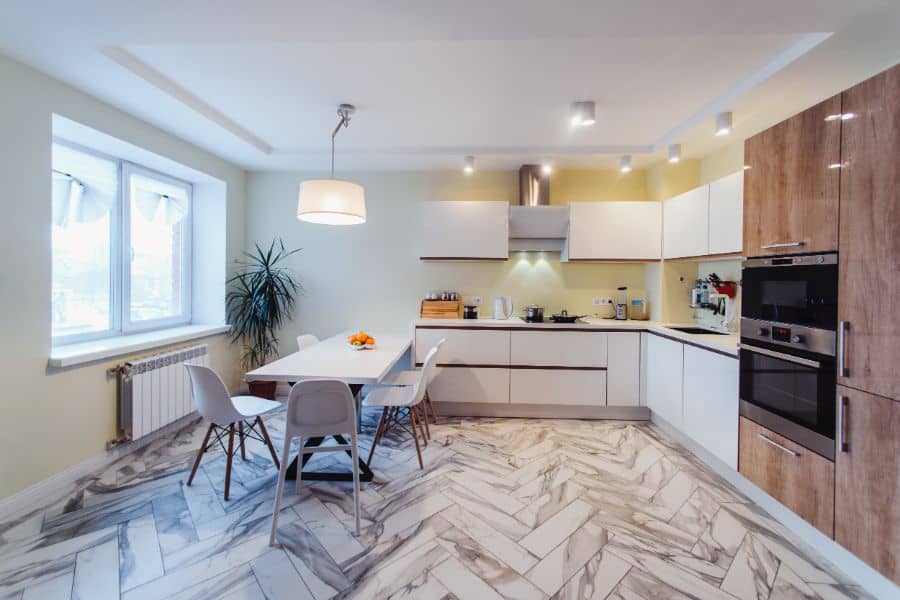 corner kitchen with white cabinets and dining room table