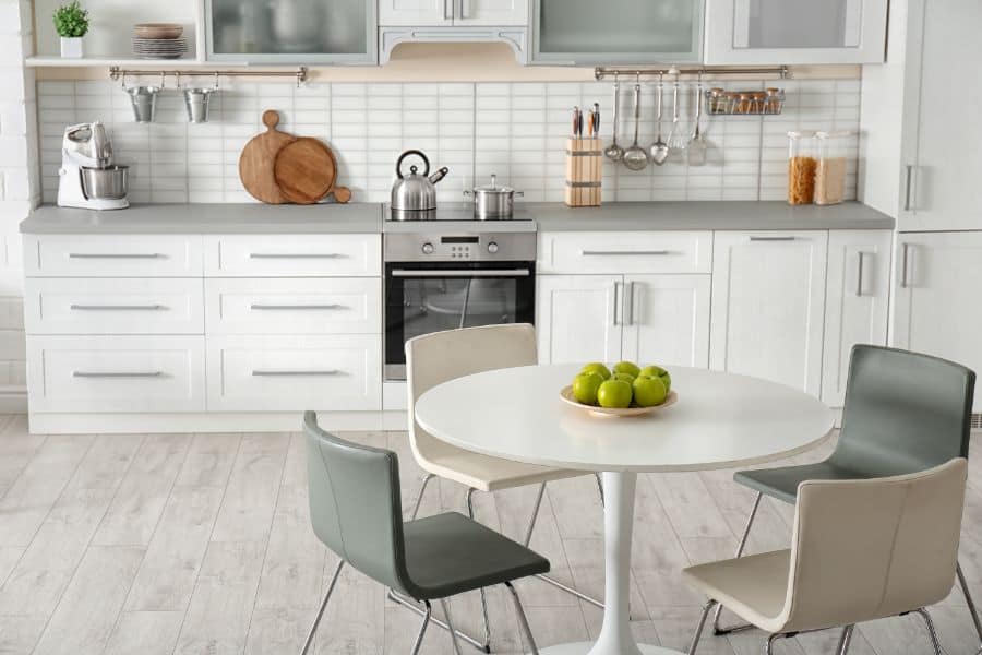 white cabinet kitchen with round dining table