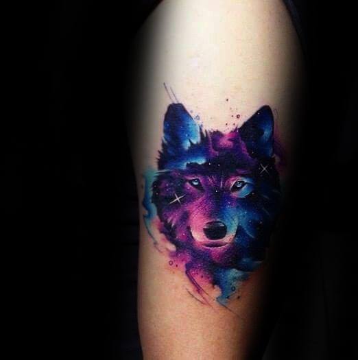 Vibrant galaxy-themed wolf tattoo with glowing eyes, deep purples and blues, and star accents for a mystical outer-space effect.