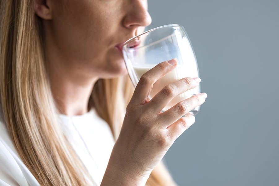 woman drinking a glass of milk