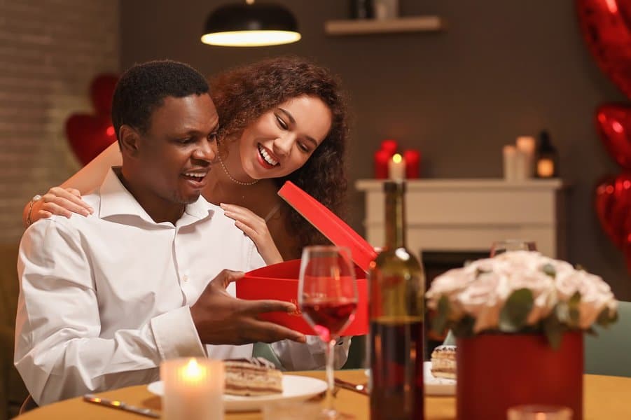 woman greeting her boyfriend on Valentine's Day at home