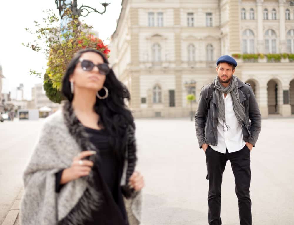 woman ignore her boyfriend and walk away