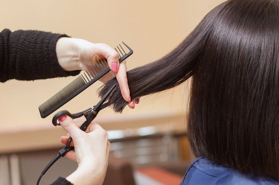 woman in a salon doing haircut