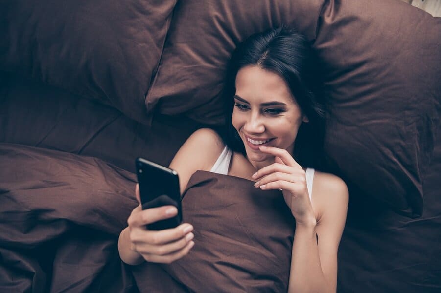 woman reading naughty texts from boyfriend