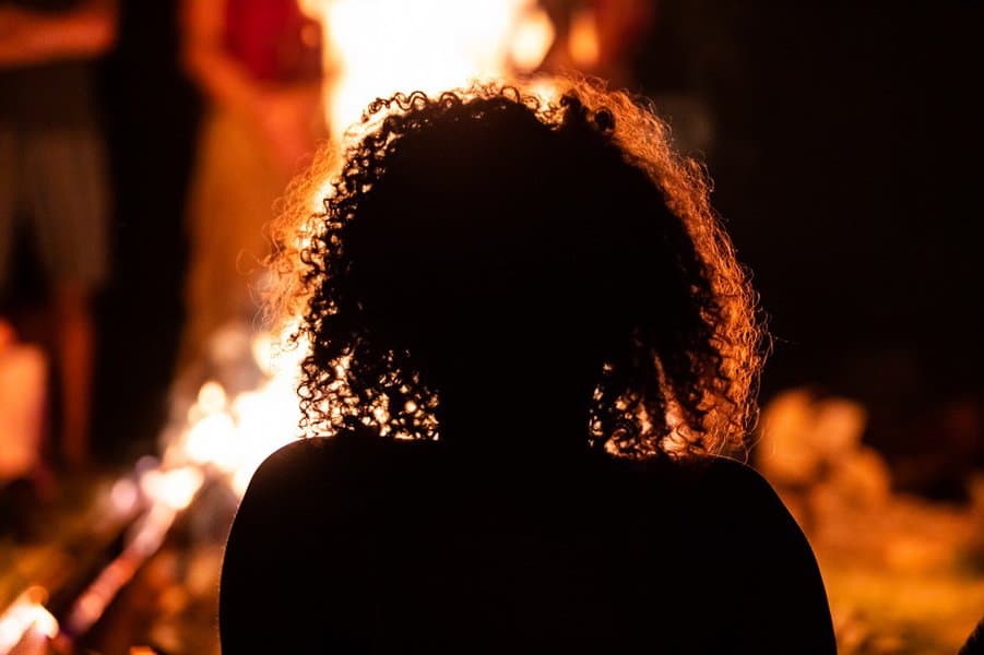 woman sitting in the front of the fire