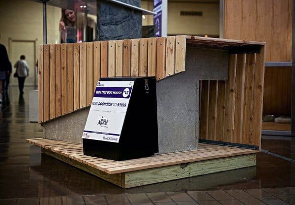 A modern dog house featuring a combination of wood and concrete materials