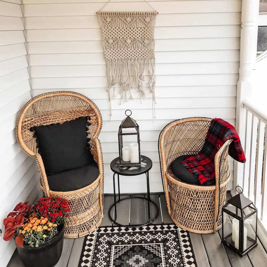 Charming patio with rattan chairs, lanterns, and a macrame wall hanging for decoration.