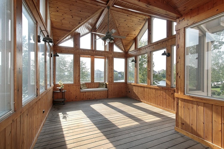 screened-in porch with wood accents