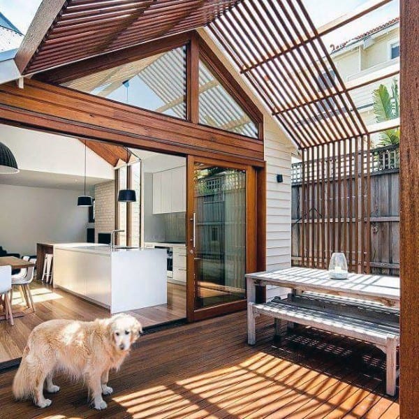 Modern wooden pergola with slatted design, seamlessly extending indoor living to the outdoor patio.