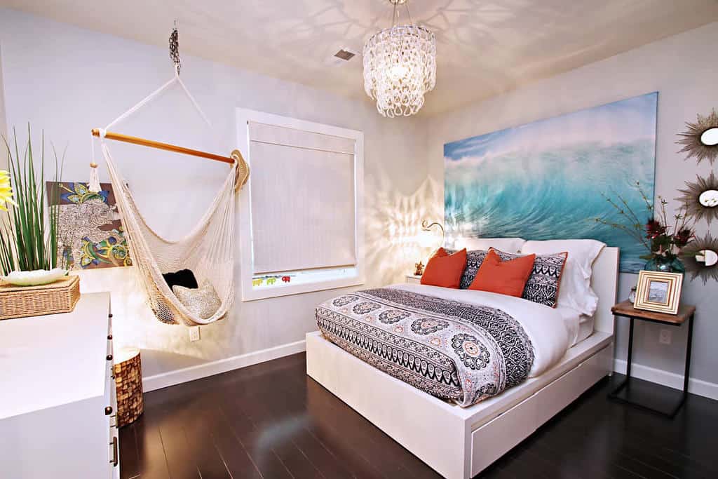 Ocean-themed bedroom with hammock, modern bed, and beach-inspired decor.