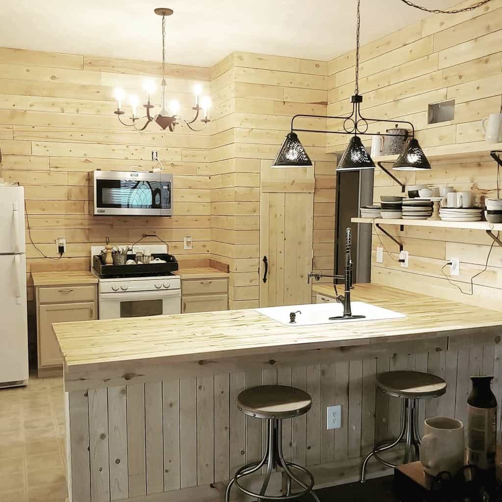 Rustic kitchen with natural wood paneling, open shelves, and industrial lighting fixtures.