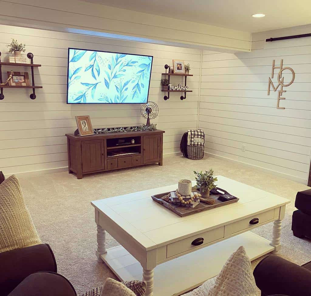 Rustic living room with shiplap walls, farmhouse decor, and wall-mounted TV.