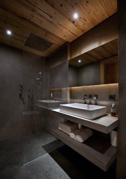 Modern bathroom with wood ceiling, concrete walls, glass shower, and floating vanity.