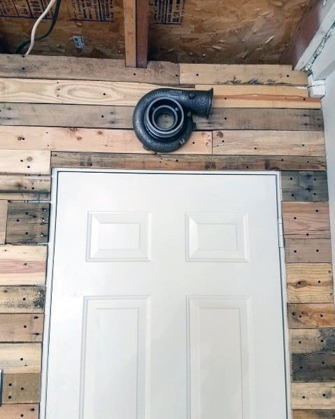 white door wood panel wall horn above door