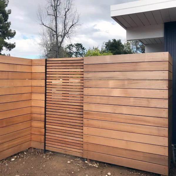 high wood panel front yard fence with gate