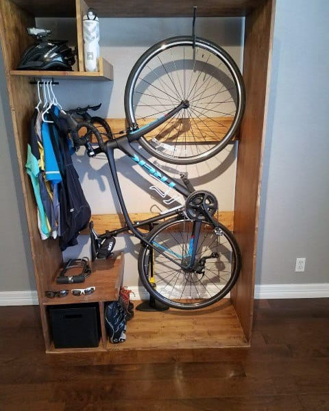 Wooden bike cabinet with storage for gear and accessories.