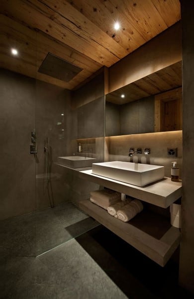 Modern bathroom with a wooden ceiling, glass shower, and sleek sink
