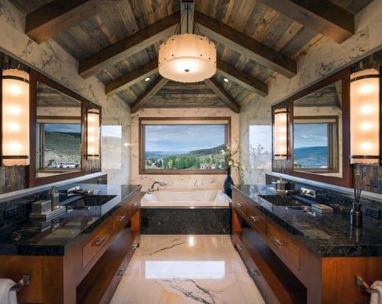 Rustic bathroom with a wooden ceiling, dual sinks, a bathtub, and a large window view