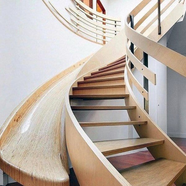 Modern interior featuring a curved staircase with a sleek wooden slide alongside it