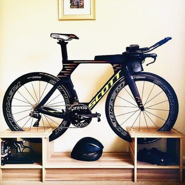Bike display with wooden shelves for storage, style, and easy access to gear.