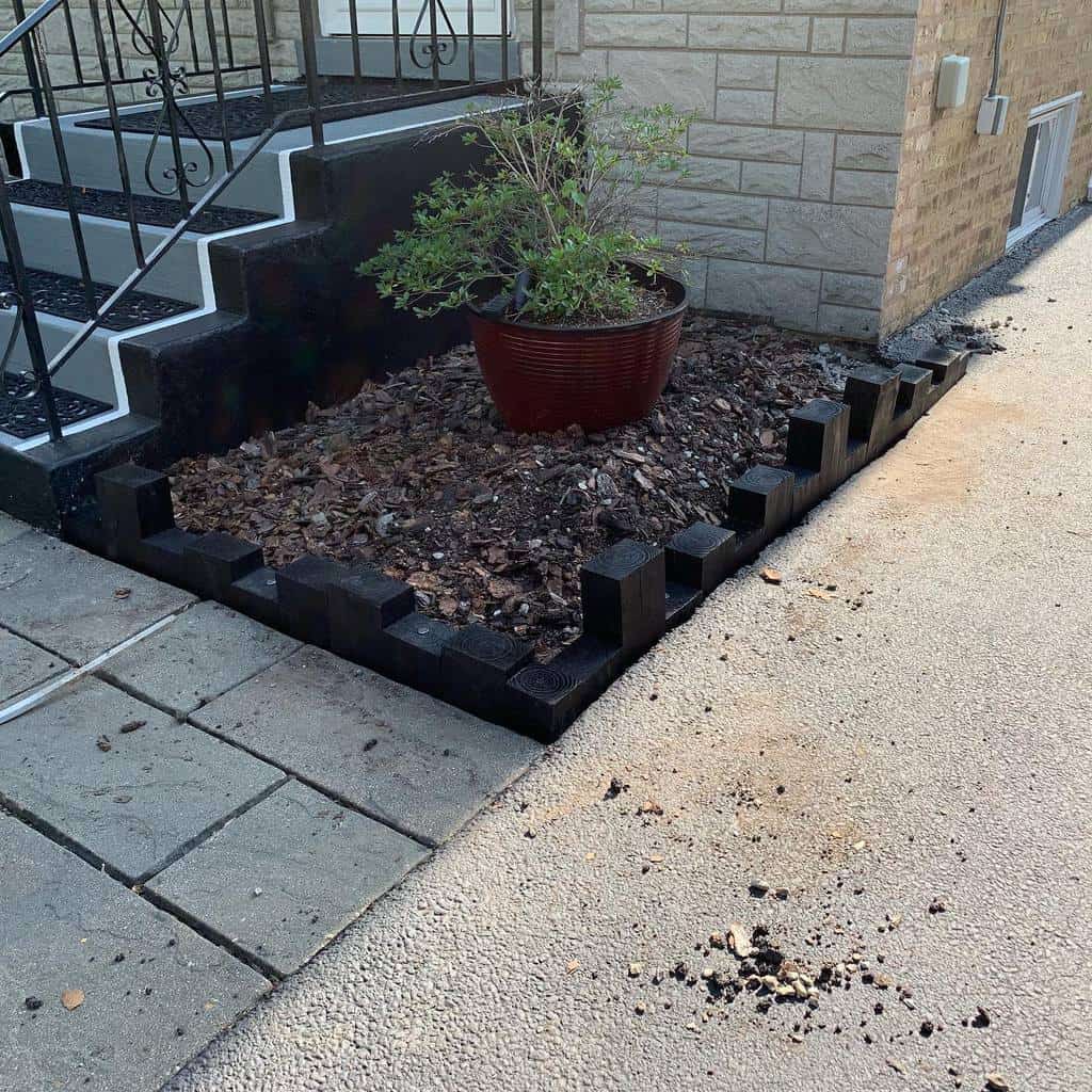 black painted wood garden edging pot plant