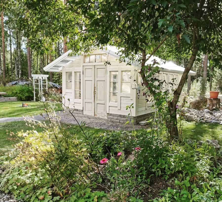white wood greenhouse large backyard