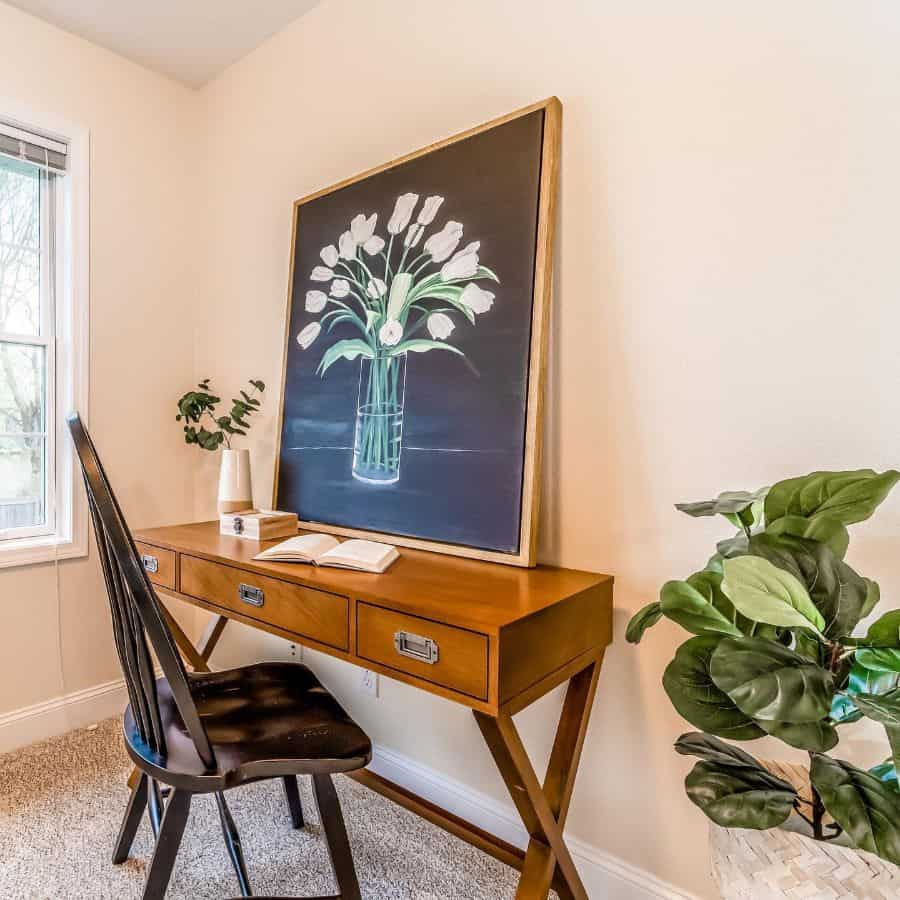 vintage wood desk with drawers framed flower artwork wood chair