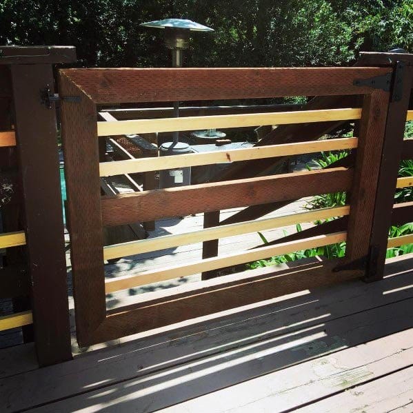 Sunny deck with a wooden gate featuring horizontal slats